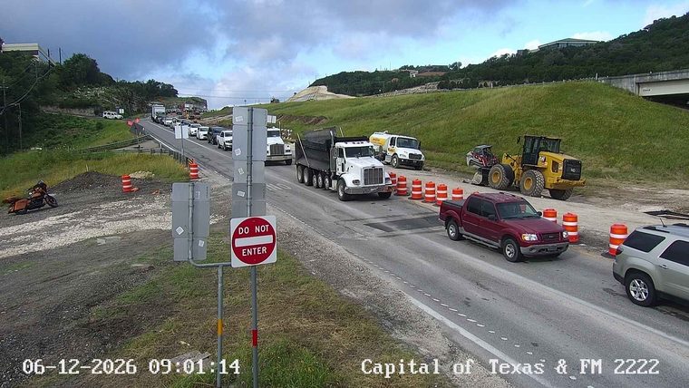Construction vehicles and traffic congestion on the roadway.