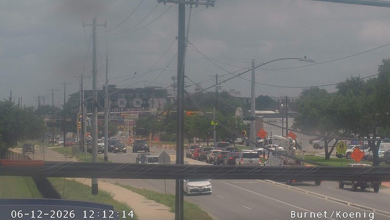 A utility truck and cones are present on the roadway, indicating a responder incident.