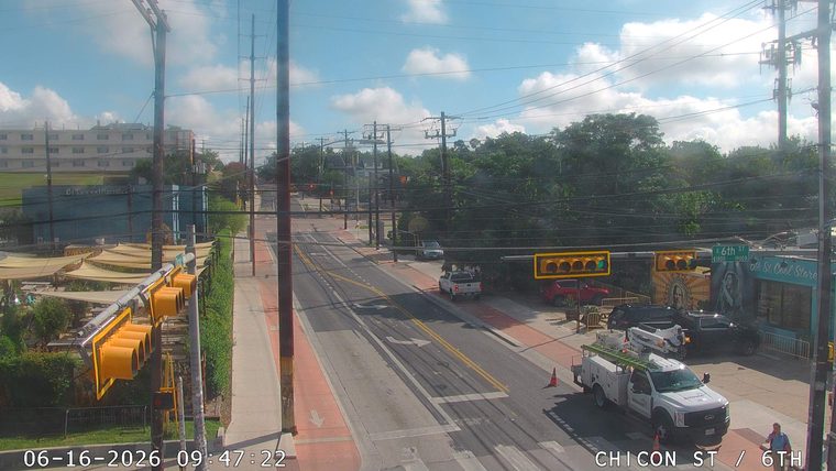Utility truck and worker on scene with traffic cones.
