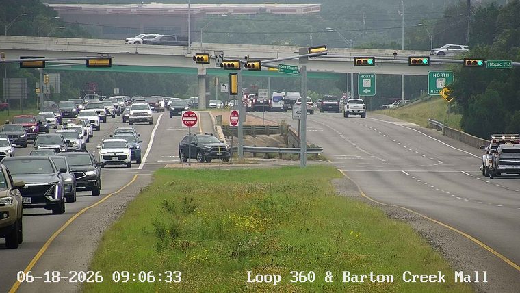 A tow truck with flashing lights is on the shoulder of the road.