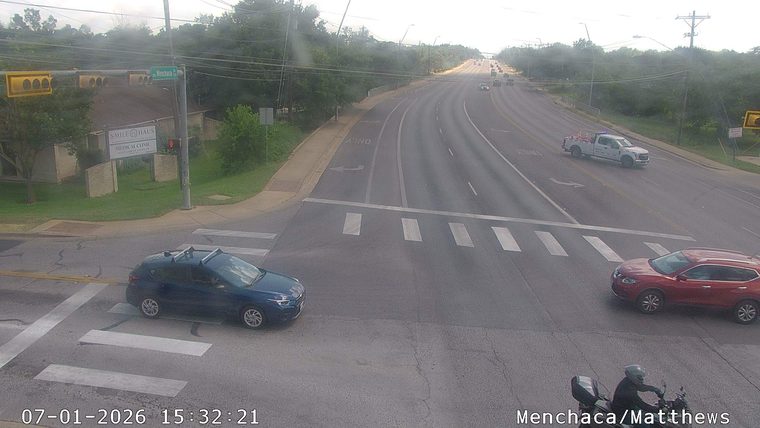 White pickup truck with blue flashing lights in the right lane