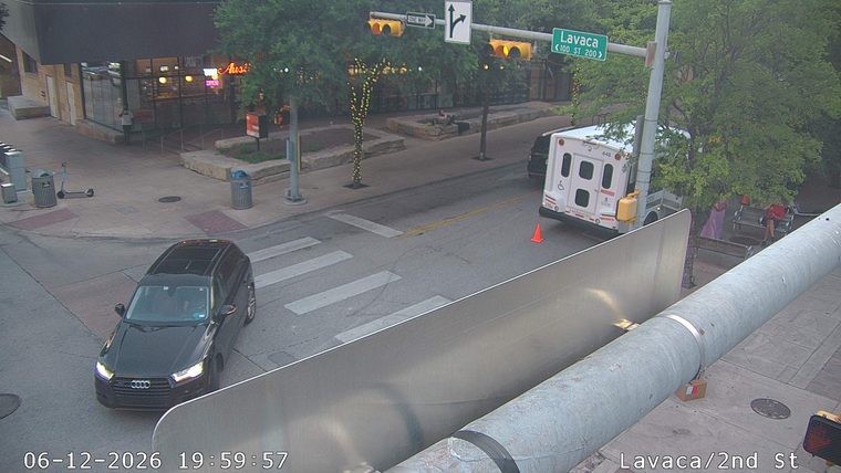 White van with orange cone behind it, possibly a responder vehicle.
