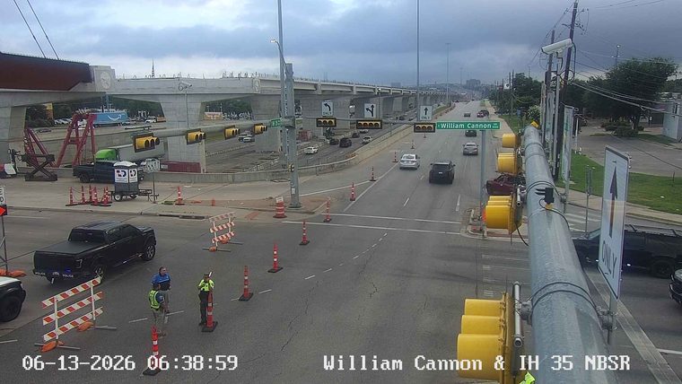 Police and construction personnel are present at a roadside construction zone.