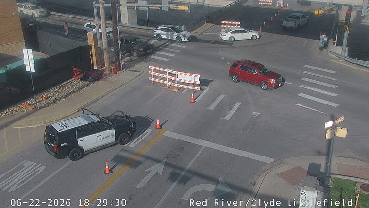 Police car with its doors open in the left lane