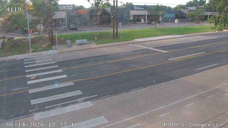 A brown object is lying on the crosswalk, potentially debris.