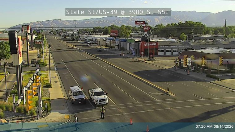 Two vehicles stopped, a person in a safety vest is present, suggesting an incident response.