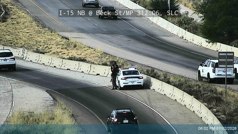 Highway Patrol vehicle with lights on the shoulder