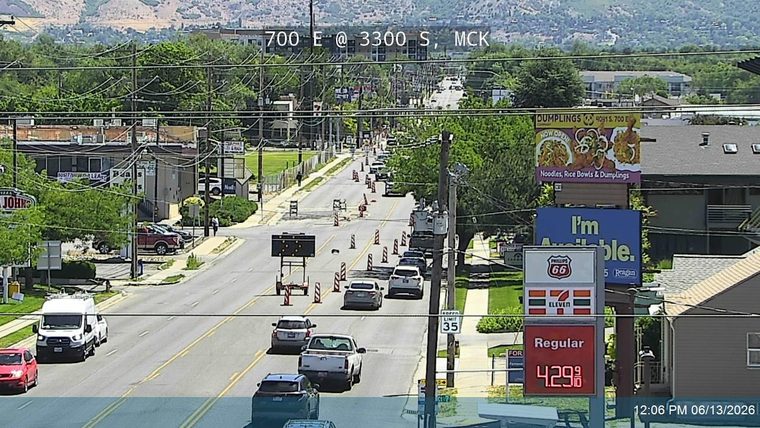 Traffic cones and a temporary sign indicate road work or an incident ahead.