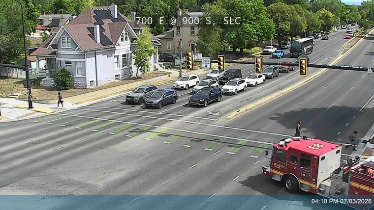 Fire truck with emergency lights on the right side of the roadway