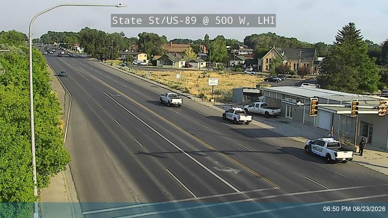 Two police cars with lights on the right shoulder