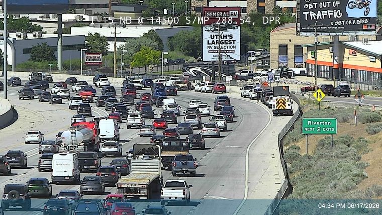 A traffic incident with a responder vehicle and cones on the right shoulder.
