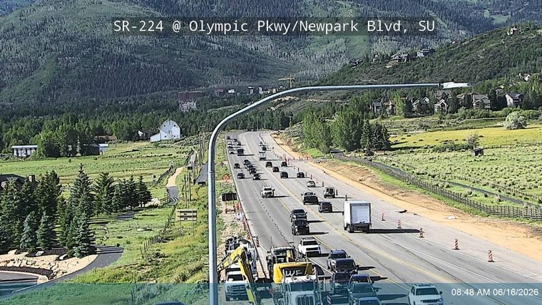 Construction vehicles and cones indicate ongoing road work or an incident response.