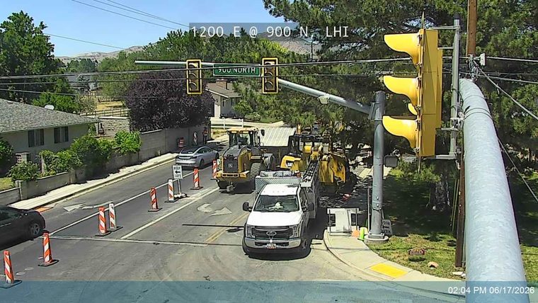 Construction vehicles and cones indicate road work or an incident response.