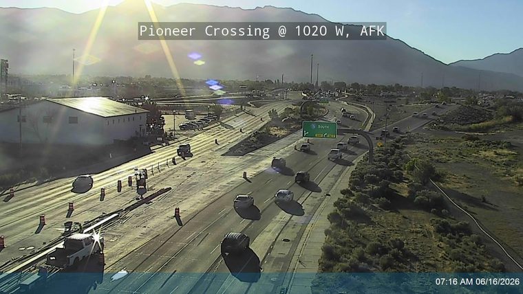 Construction zone with cones and a truck, traffic moving slowly.