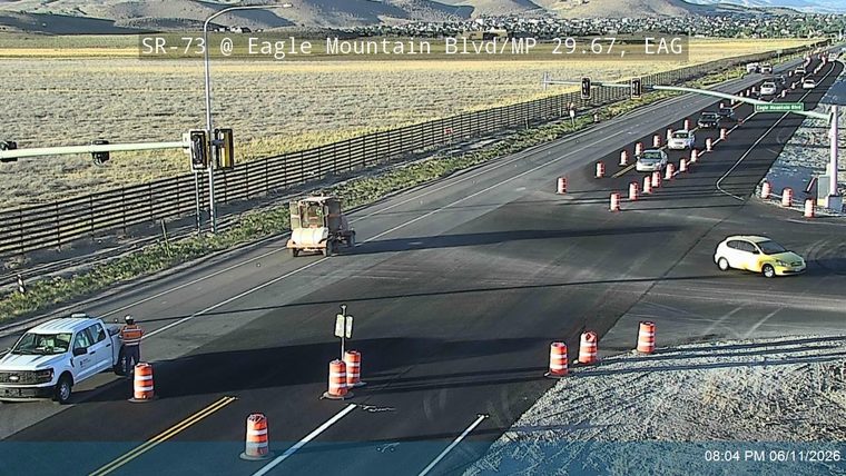 Road work with personnel and equipment on the roadway.