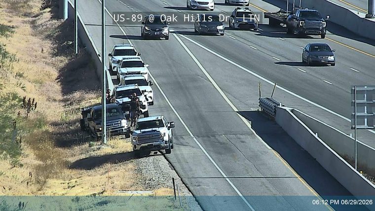 Multiple police vehicles and officers on the right shoulder