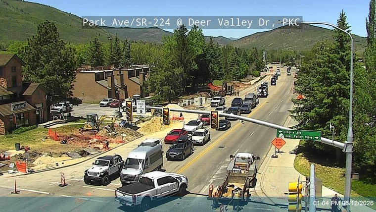 Road construction with workers and equipment present on the roadway.