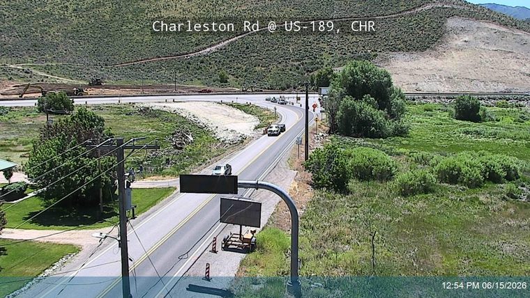 Multiple emergency vehicles and cones on the roadway, indicating an incident response.