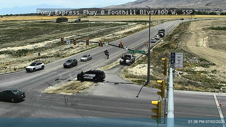 Police car and tow truck attending to a white pickup truck in the intersection