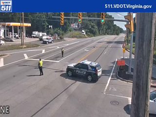 Police car and officers directing traffic at an intersection.