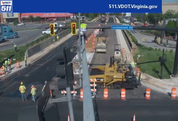 Road construction with workers and equipment present on the roadway.