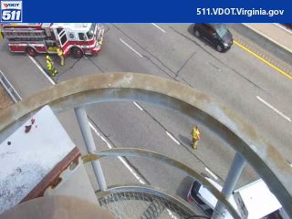 Fire truck and personnel on the roadway responding to an incident.