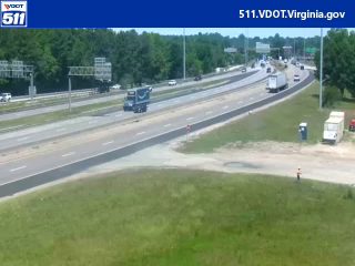 Emergency responder and vehicle on the shoulder of the highway.