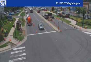 Road work with personnel and cones present on the roadway.