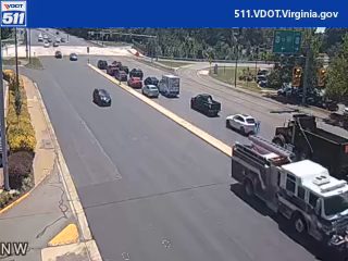 Fire truck with lights on in the right lane