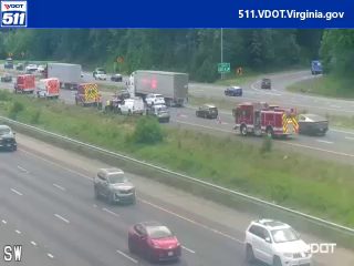 Fire trucks and emergency vehicles on the highway, indicating an incident response.