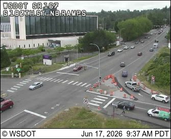Emergency responders and cones are present at a construction zone on the roadway.