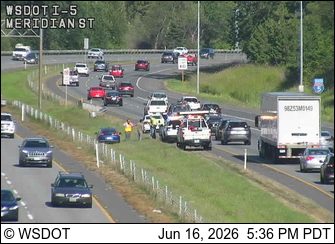 Emergency responders on the side of the highway with vehicles and personnel.