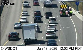 Emergency responders and tow truck at a roadside incident with multiple vehicles involved.
