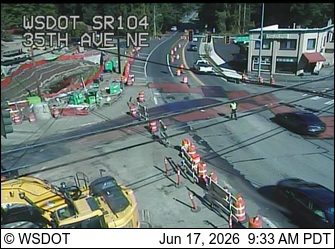 Construction zone with workers and equipment present on the roadway.