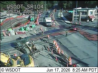 Construction zone with workers and equipment on roadway.
