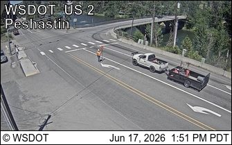 Worker directing traffic near a construction site with vehicles present vehicles.