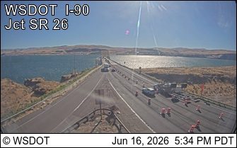 Road work with cones and a truck on the right shoulder of I-90.