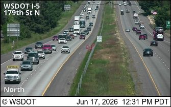 Emergency responders with cones on the shoulder of I-5 near 179th St N.