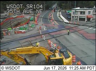 Construction zone with workers and equipment on the roadway.