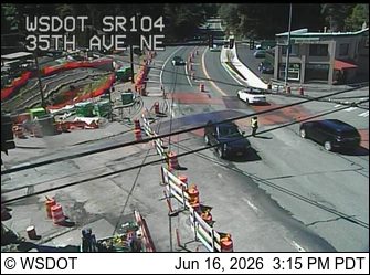Person in high-visibility vest directing traffic near construction zone of construction zone.