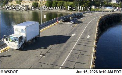 White truck with open door and cones on the road, likely a responder scene response.