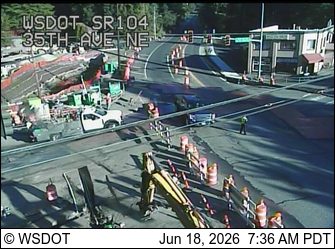 Construction zone with workers and equipment present on the roadway.
