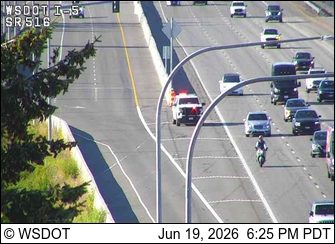 Police car with red and blue lights on the right shoulder