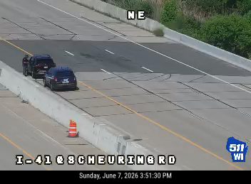 Police vehicles and officers on the shoulder of I-41 near Scheuring Road.