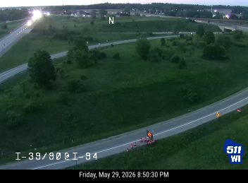 Emergency vehicle and cones on the side of the road.