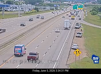 Emergency responders and vehicles are present on the shoulder of the highway.