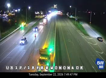 Construction cones and a worker in the left lane