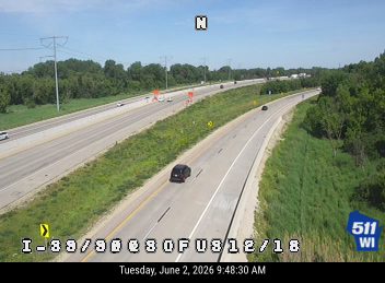 Emergency vehicles and cones on the right shoulder of I-89/90.