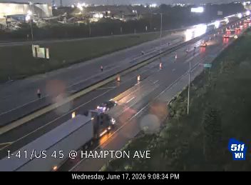 Construction cones and workers in the left lane