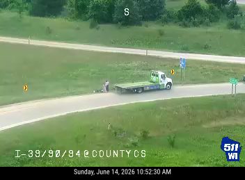 Tow truck and person assisting a motorcycle on the right shoulder